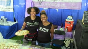 two women holding food samples at a festival in hudson valley ny