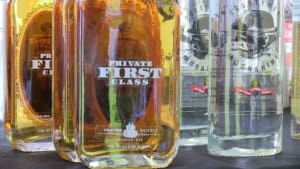 bottles of private first class whiskey and moonshine on a table at a festival in new york