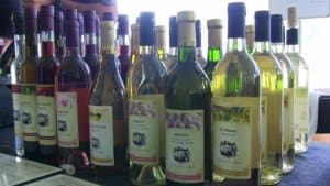 new york state wines lines up on a table at a fest