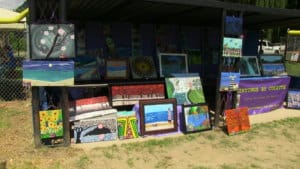 a vendor showcasing their art and paintings in upstate new york